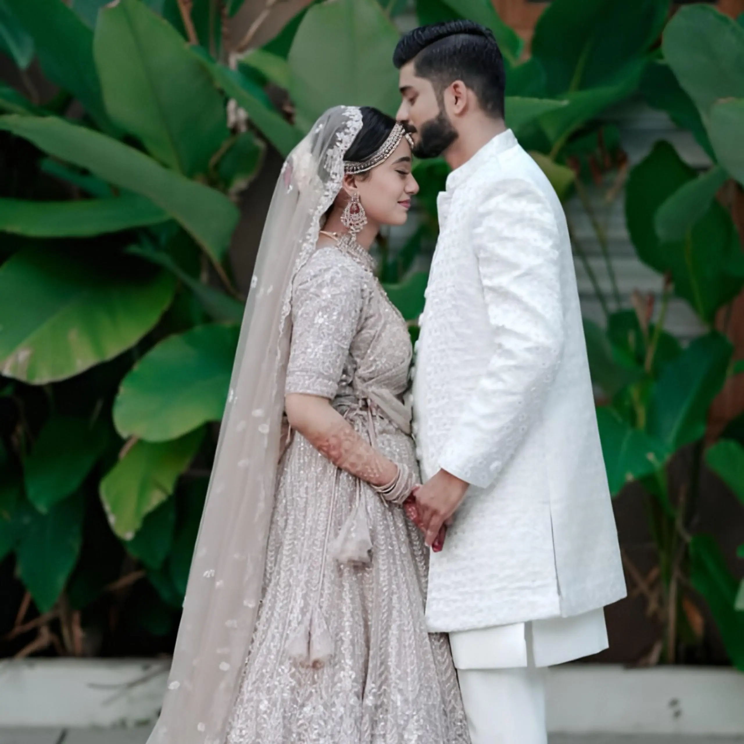 Bride and groom holding hands in a wedding moment, captured by the best wedding photographer in Malappuram