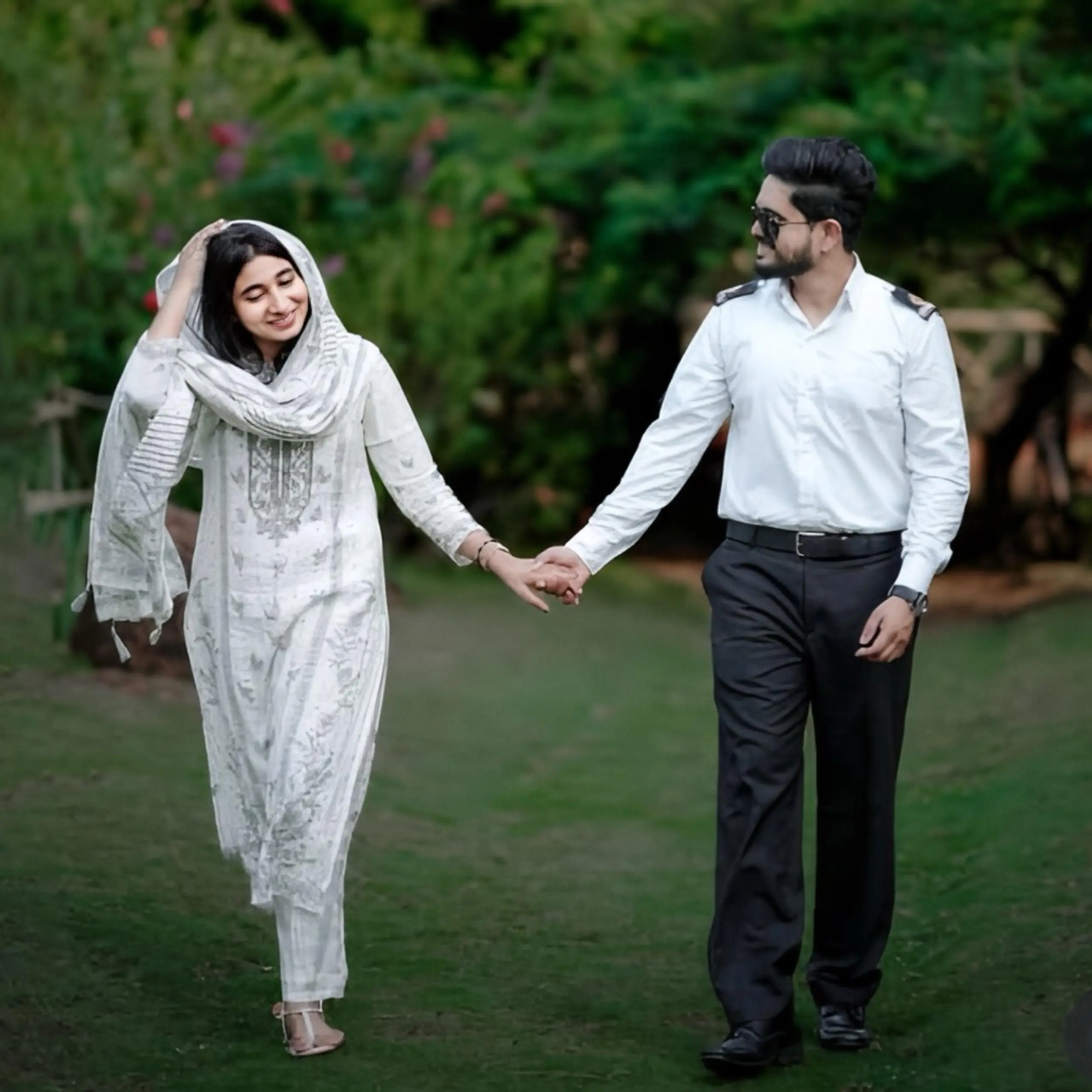 Bride and groom holding hands, smiling, and walking together in a joyful save-the-date moment, captured by the best wedding photographer in Malappuram