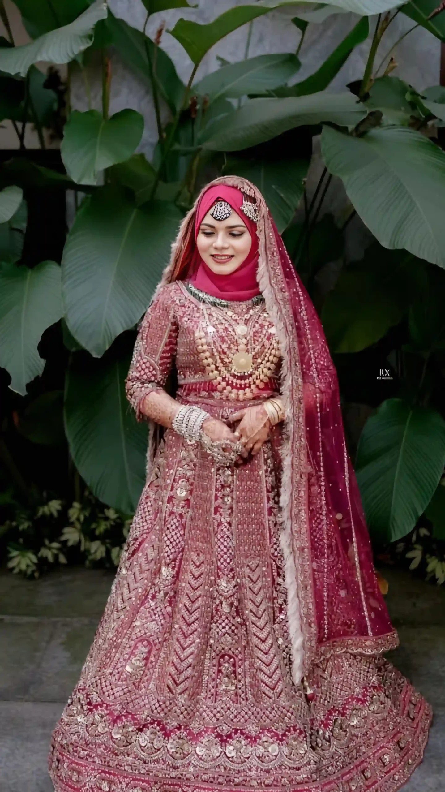 Bride in a red gown with hijab posing gracefully, captured by the best wedding photographer in Malappuram